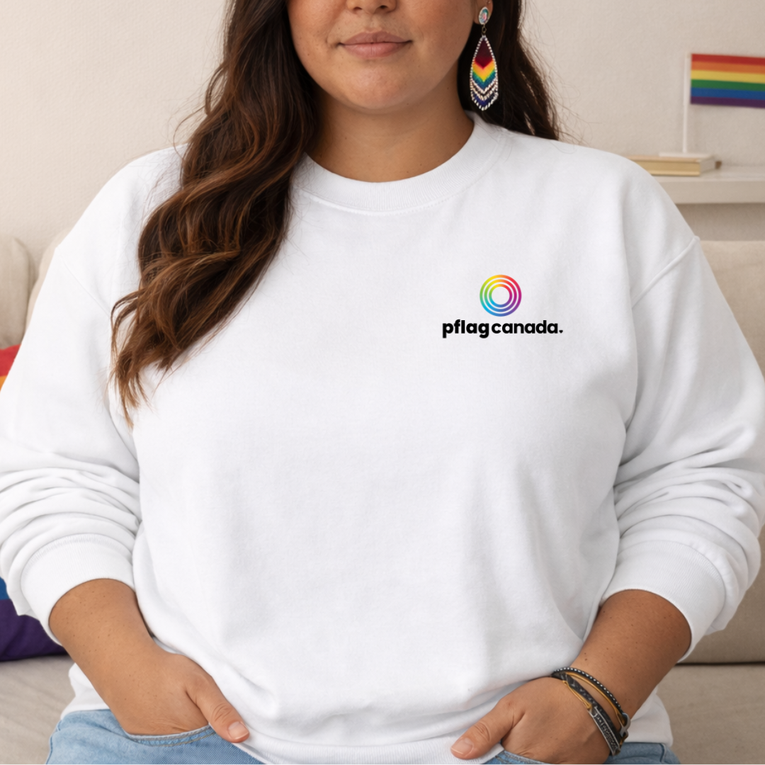 person wearing white pflag canada sweatshirt with logo on chest