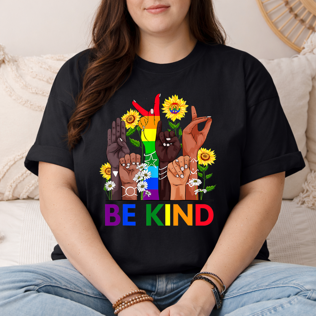 person wearing black asl pride shirt with be kind sign language design