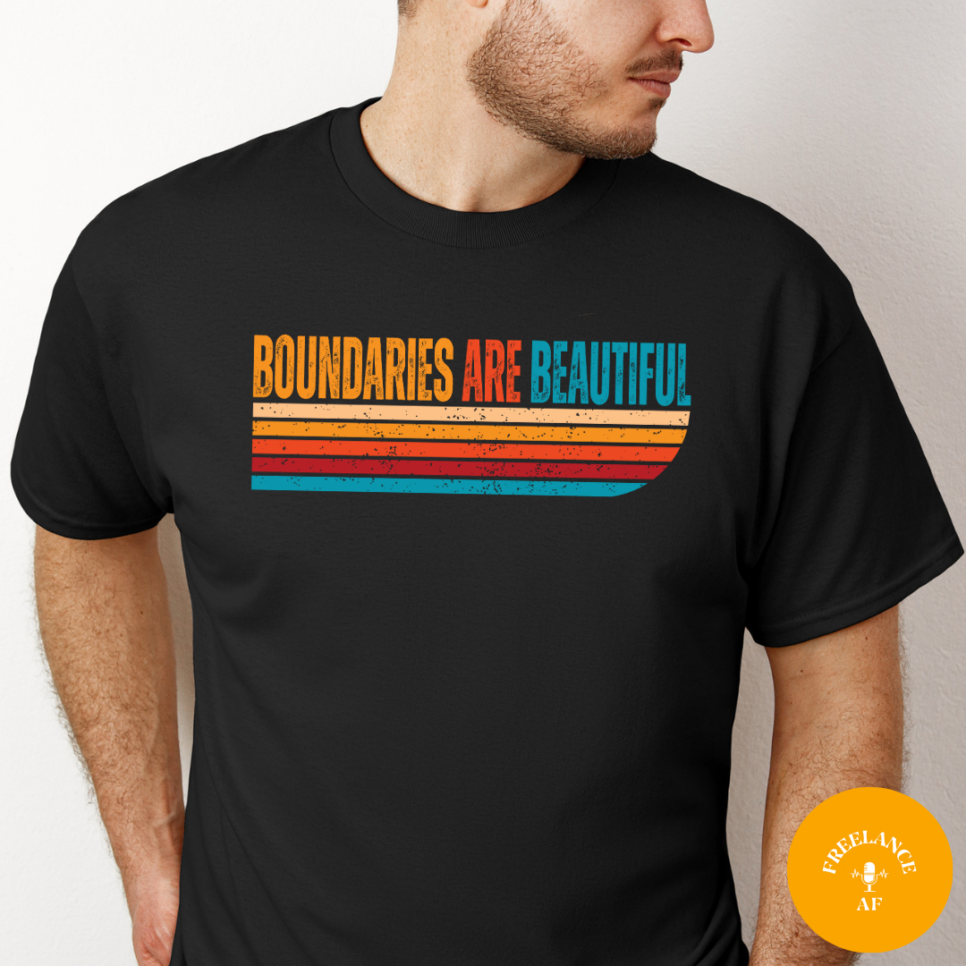 Man wearing a black Boundaries Are Beautiful T-shirt with a colourful retro graphic