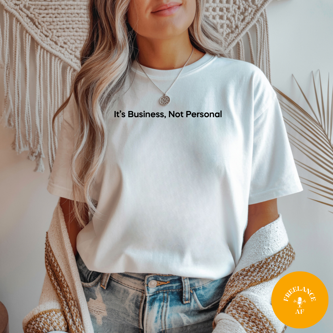 Woman wearing a white It’s Business, Not Personal T-shirt for freelancers and small business owners