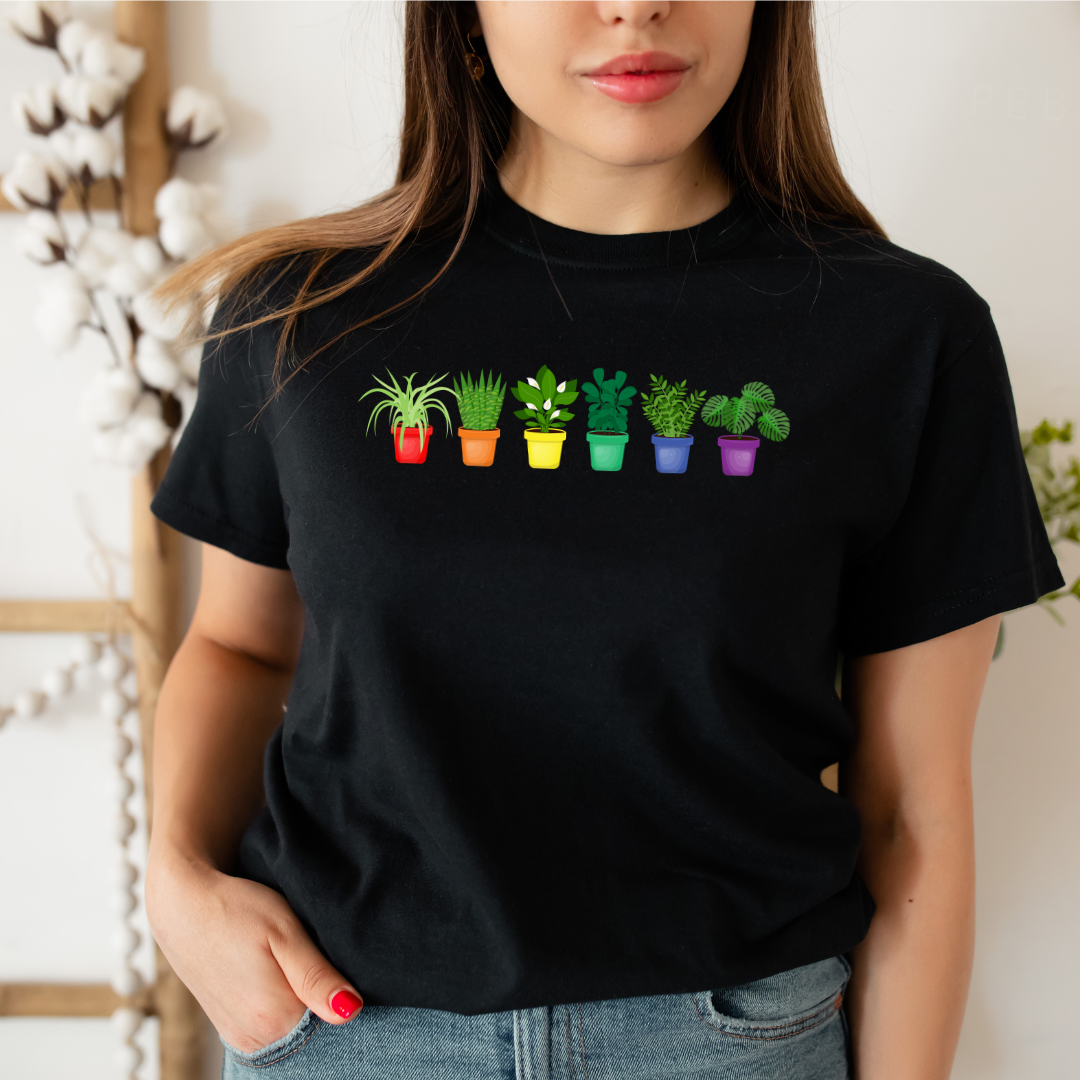 person wearing black pride plants pride shirt with rainbow plant design