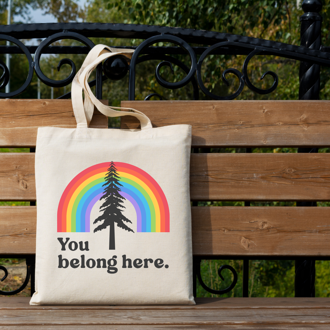 natural canvas you belong here rainbow pinetree tote bag with pride rainbow design on front