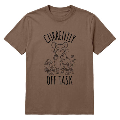 A brown short-sleeve crewneck t-shirt featuring a black line art graphic of a mouse holding an acorn and a small backpack, with the text 'CURRENTLY OFF TASK' printed around the illustration.