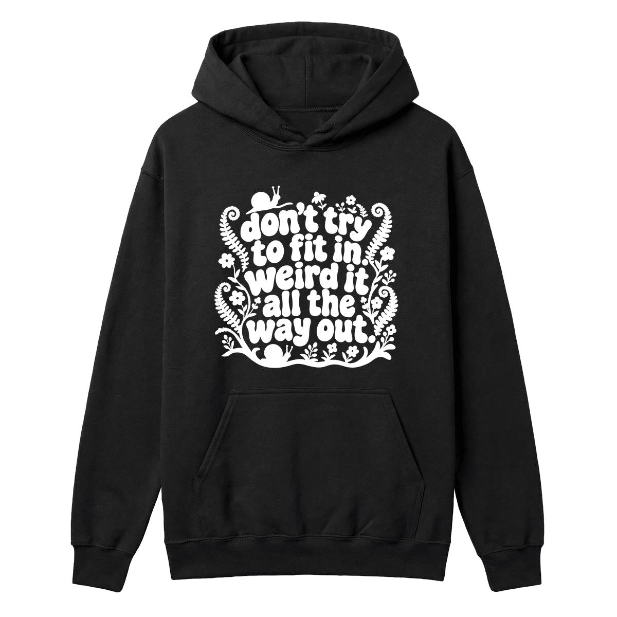 A black pullover hoodie with a white graphic text print on the chest that reads 'don't try to fit in weird it all the way out' surrounded by decorative fern and floral illustrations, shown on a plain white background.