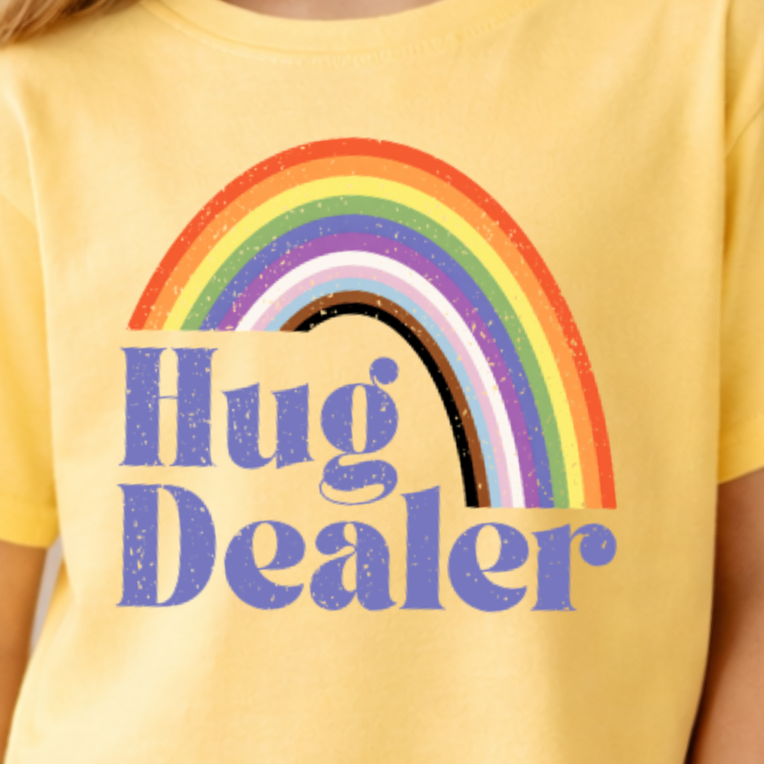 close up of yellow haze hug dealer youth t shirt showing retro rainbow design
