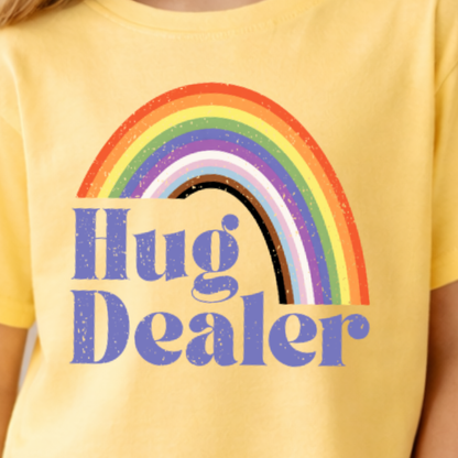 close up of yellow haze hug dealer youth t shirt showing retro rainbow design