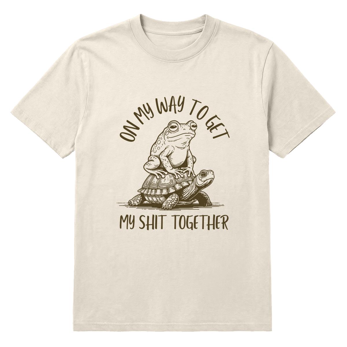 Ivory T-shirt with frog riding a turtle and “On My Way to Get My Shit Together” text