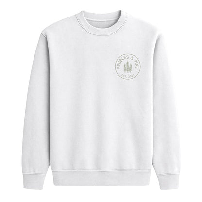 White crewneck sweatshirt with small Pebbles & Pine Est. 2021 pine tree logo on the chest