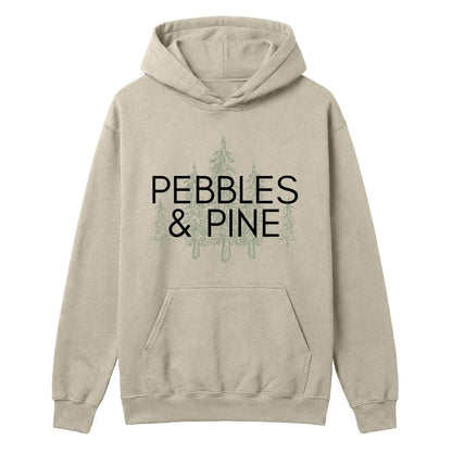 Sand hoodie with Pebbles & Pine text over a pine tree graphic on the front