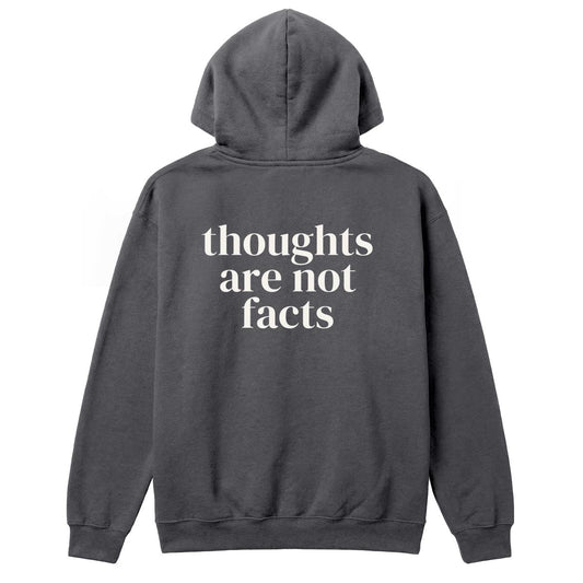 Back of charcoal hoodie with large “Thoughts Are Not Facts” text