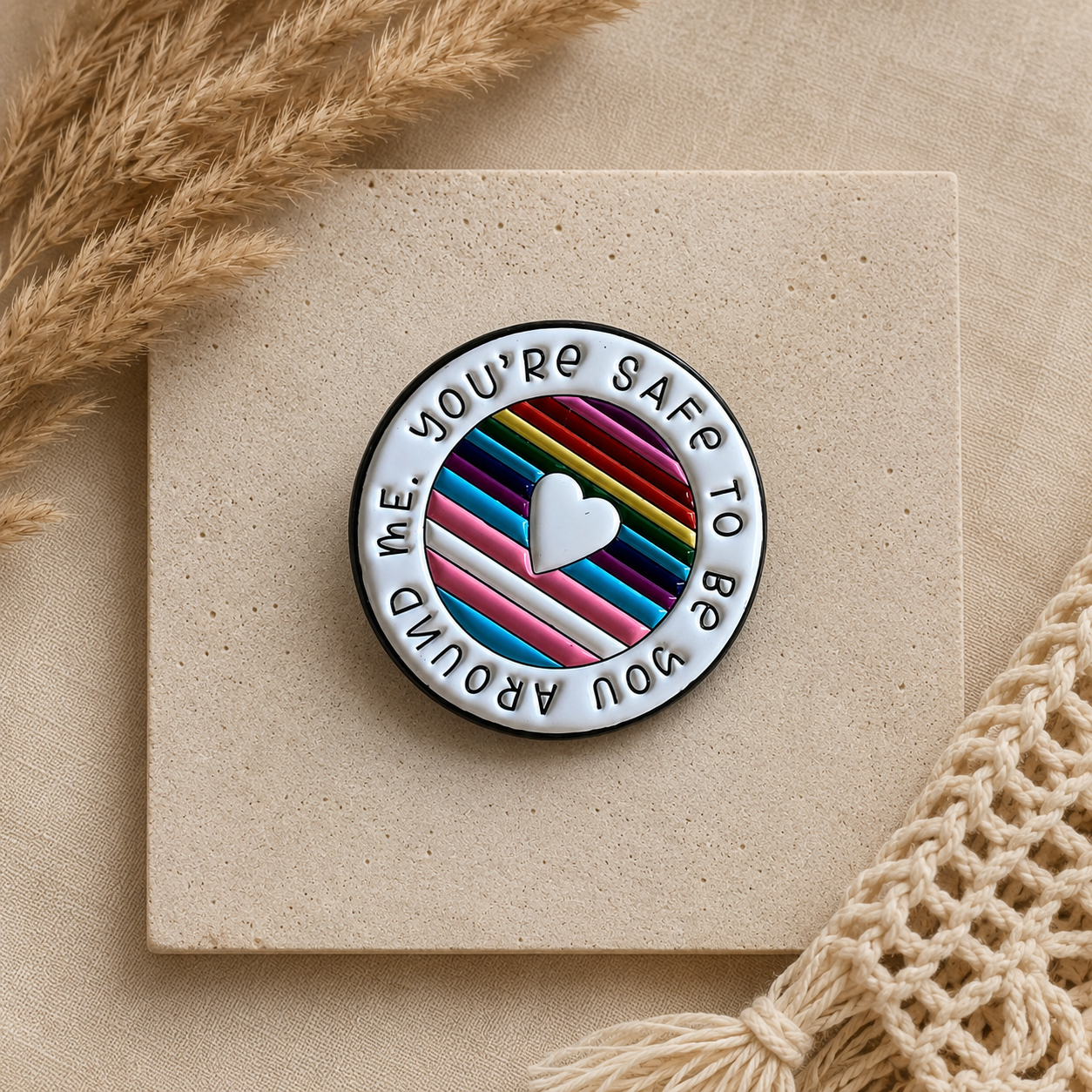 pride enamel pin with rainbow and trans colours that says you’re safe to be you around me